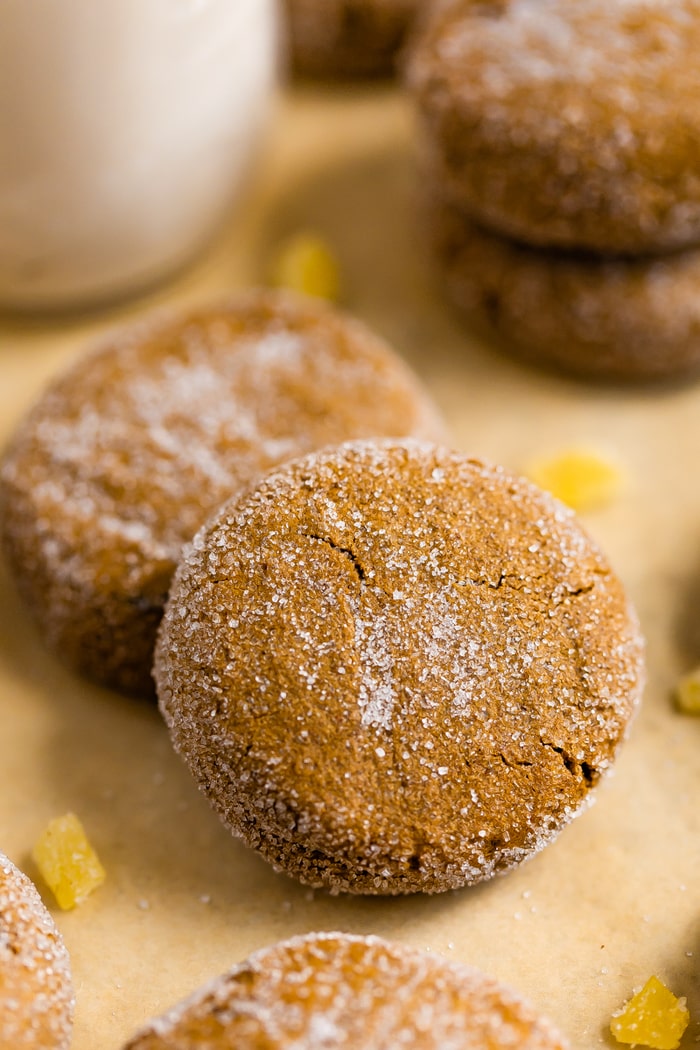 Two gingersnaps cookies on a cookie sheet.