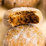 3 gingersnap cookies. The middle one has a bite taken out of it.