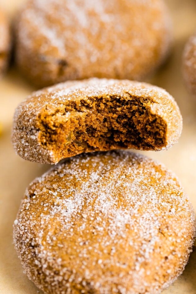 3 gingersnap cookies. The middle one has a bite taken out of it.