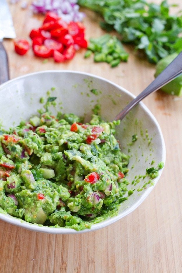 Lower fat, pea guacamole made with frozen peas, avocado, onion and tomato.