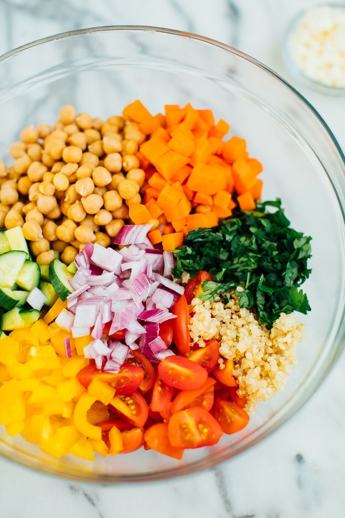 Ingredients for the quinoa chickpea salad in a bowl with feta on the side. 