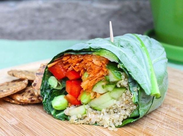 Edamame Quinoa Collard Wrap sitting on wood cutting board