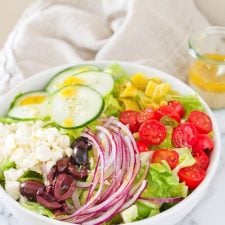 Homemade Greek Salad in a white bowl.