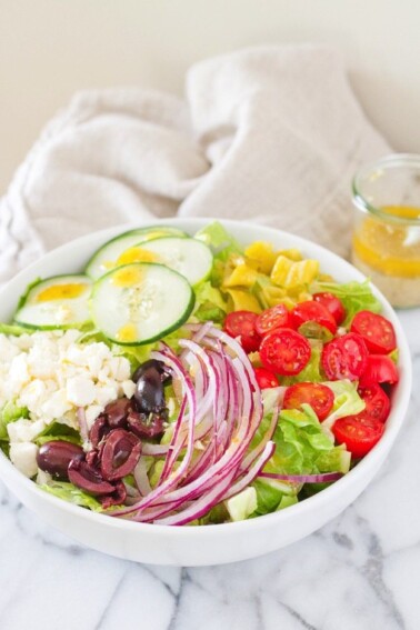 Homemade Greek Salad in a white bowl.