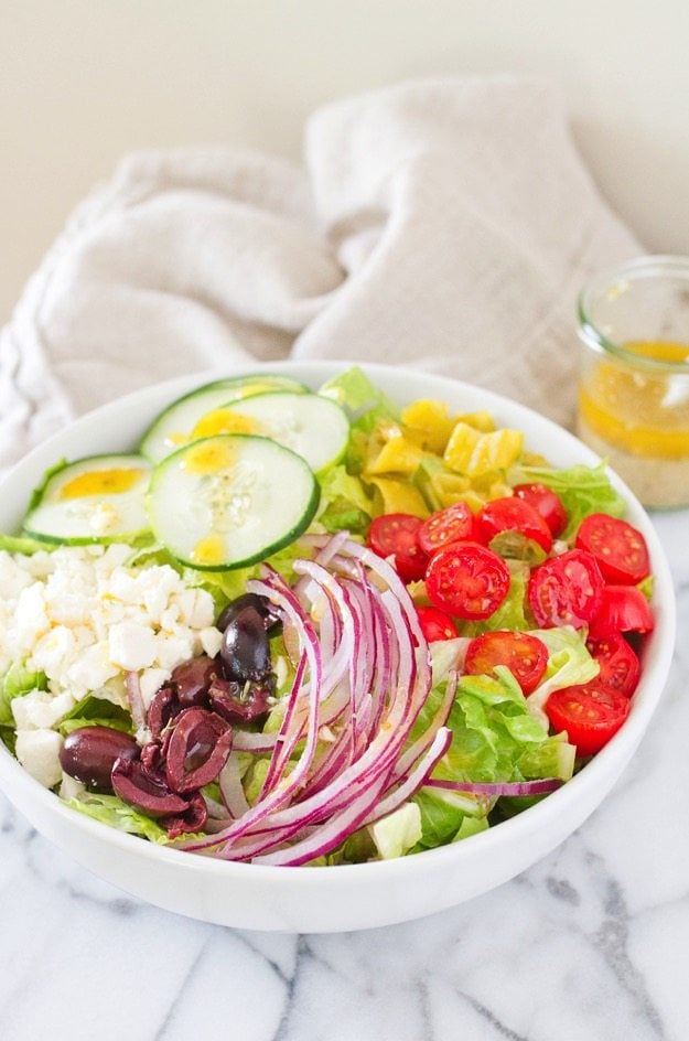 Homemade Greek Salad in a white bowl.