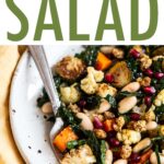 Bowl with roasted vegetable salad with kale and beans.