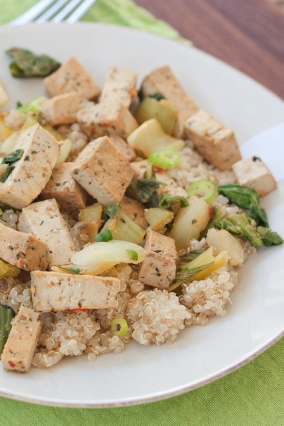 White plate with Tofu Bok Choy Stir Fry on a green towel