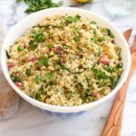 Spring quinoa salad with roasted asparagus and radishes in bowl.