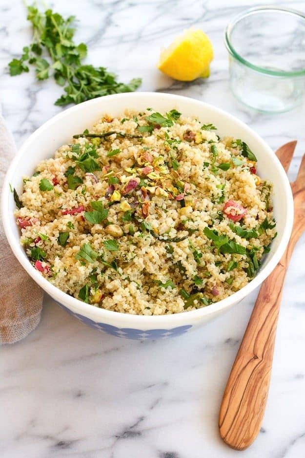 Spring quinoa salad with roasted asparagus and radishes in bowl.