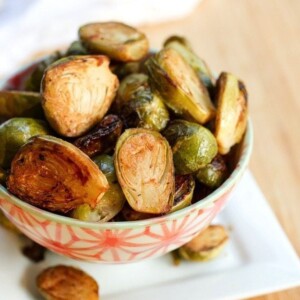 Date sweetened balsamic glazed brussels sprouts in a decorative serving bowl.