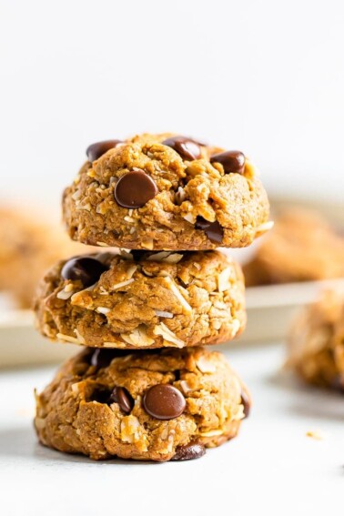 Stack of three chocolate chip peanut butter oatmeal cookies with coconut.