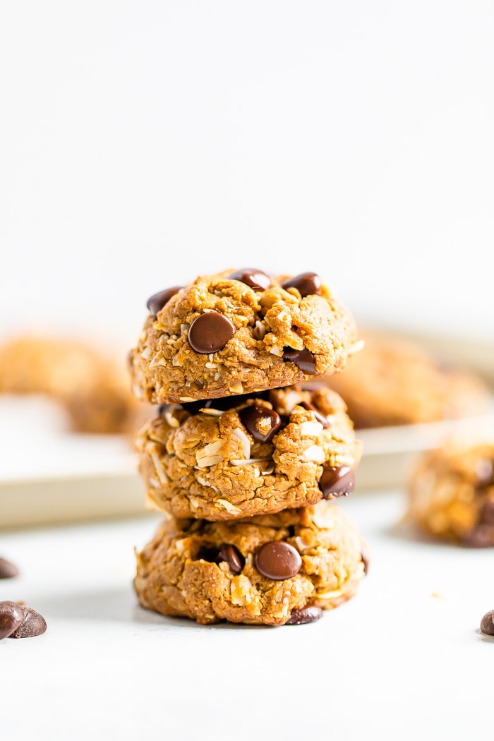 Stack of three chocolate chip peanut butter oatmeal cookies with coconut.