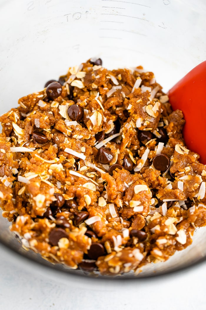 Cookie dough for peanut butter oatmeal cookies with chocolate chips and coconut flakes.