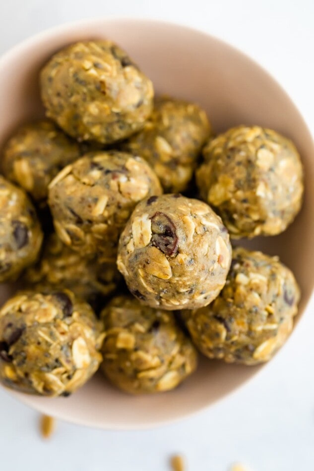 Energy bites made with sunbutter in a pink bowl.