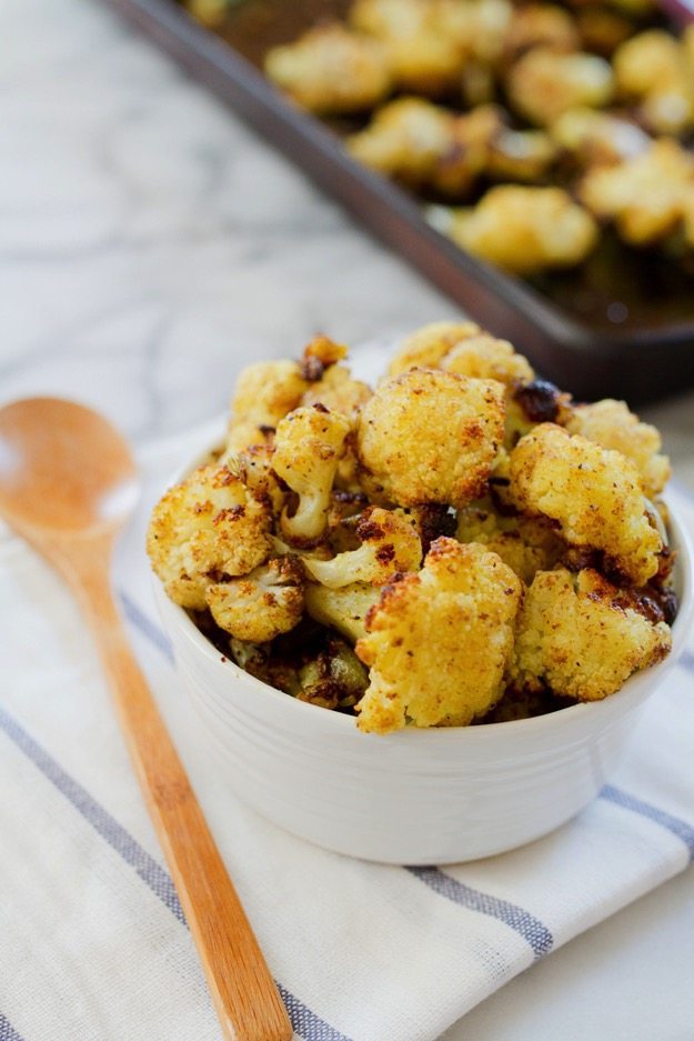 Curried cauliflower roasted to perfection with coconut oil, curry powder, garam masala and fennel seeds. It’s easy to whip up, amazingly flavorful and one of my all-time favorite vegetable side dishes. 
