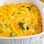 Broccoli quinoa casserole with cheddar cheese in a baking dish.