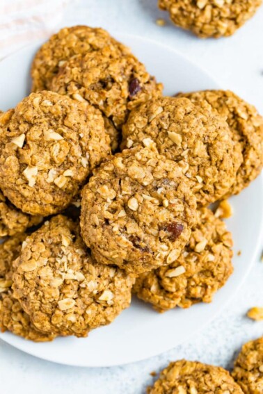 Oatmeal date cookies on a white plate.