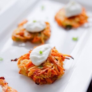 A close up of Sweet Potato and Parsnip Spiralized Latkes on a serving platter.