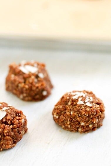A close up of 3 no-bake coconut quinoa bites.