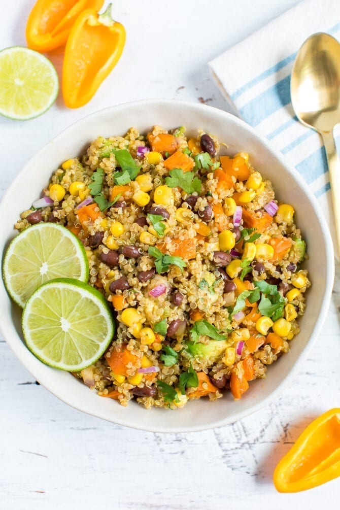 Bowl of quinoa salad with corn, sweet potatoes, corn, cilantro, and black beans.