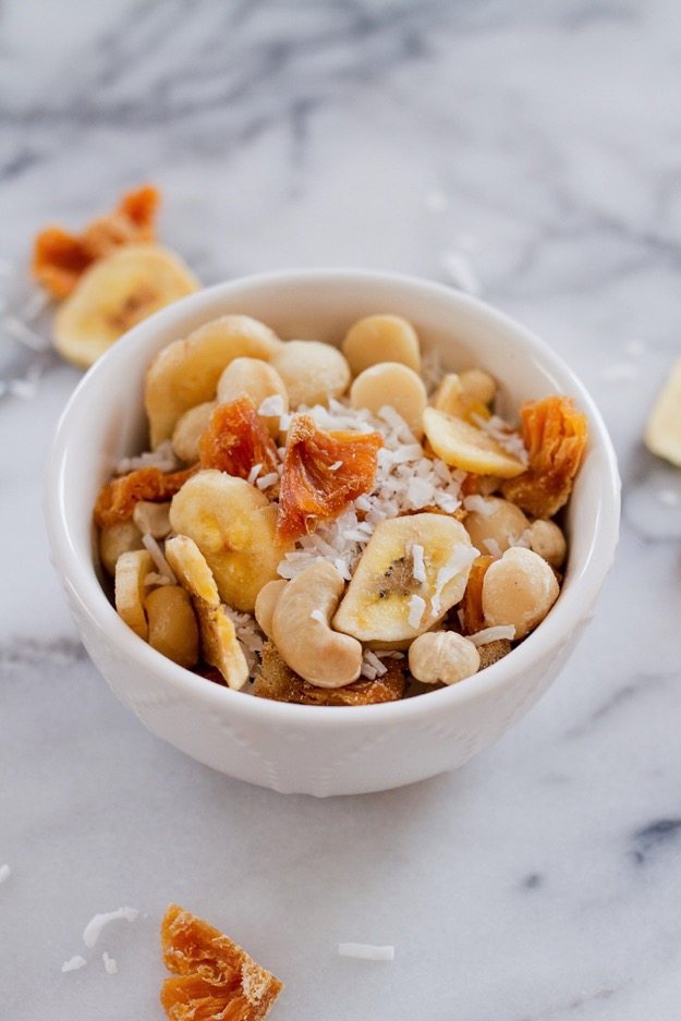 Take a trip to the tropics with this island-inspired tropical trail mix with cashews, macadamia nuts, banana chips, dried pineapple and coconut.