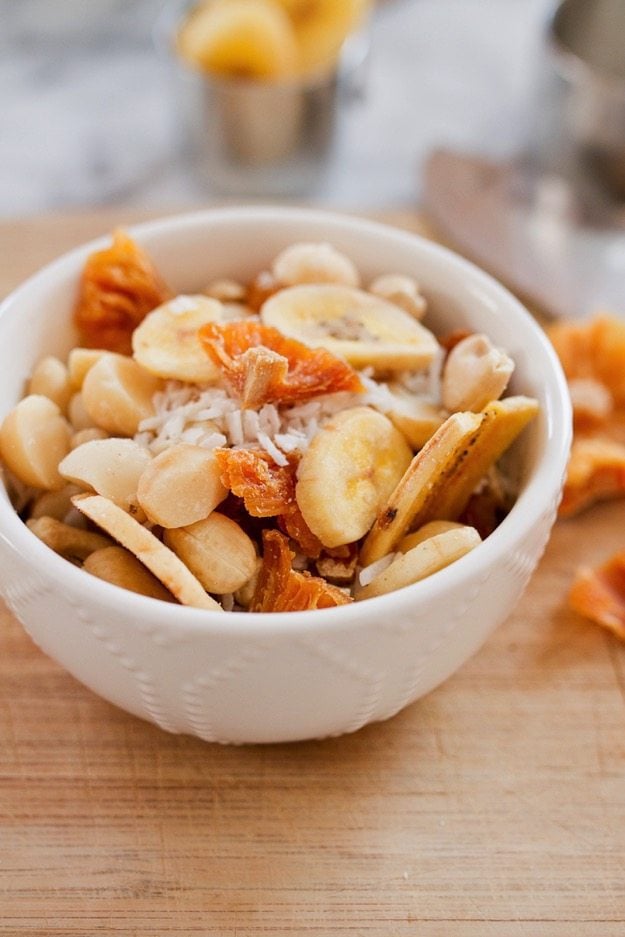 Take a trip to the tropics with this island-inspired tropical trail mix with cashews, macadamia nuts, banana chips, dried pineapple and coconut.