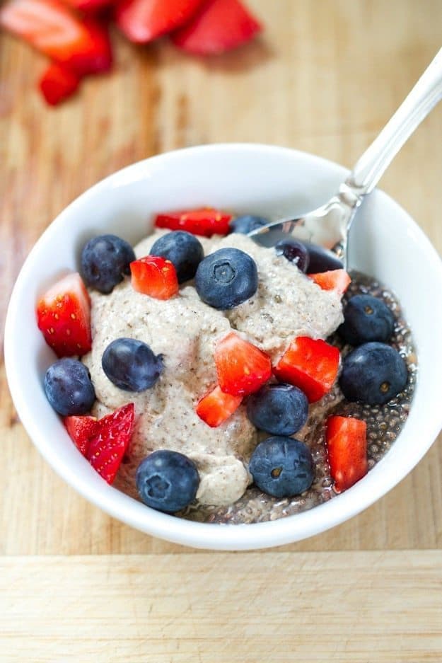 A bowl of creamy cashew chia pudding with a spoon resting in the bowl.