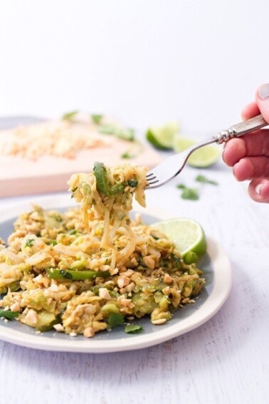 Pad Thai with Cabbage Noodles on a plate. A fork is holding up a bite.