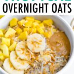 Bowl of overnight oats topped with pineapple, mango, coconut, banana and peanut butter.