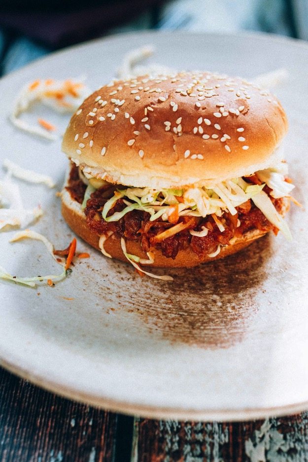 The BEST vegan BBQ sandwich made with shredded hearts of palm, homemade BBQ sauce and a crunchy apple cider vinegar coleslaw. 