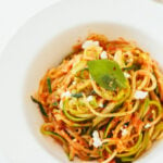 Inspiralized tomato basil zucchini pasta with goat cheese and asparagus.