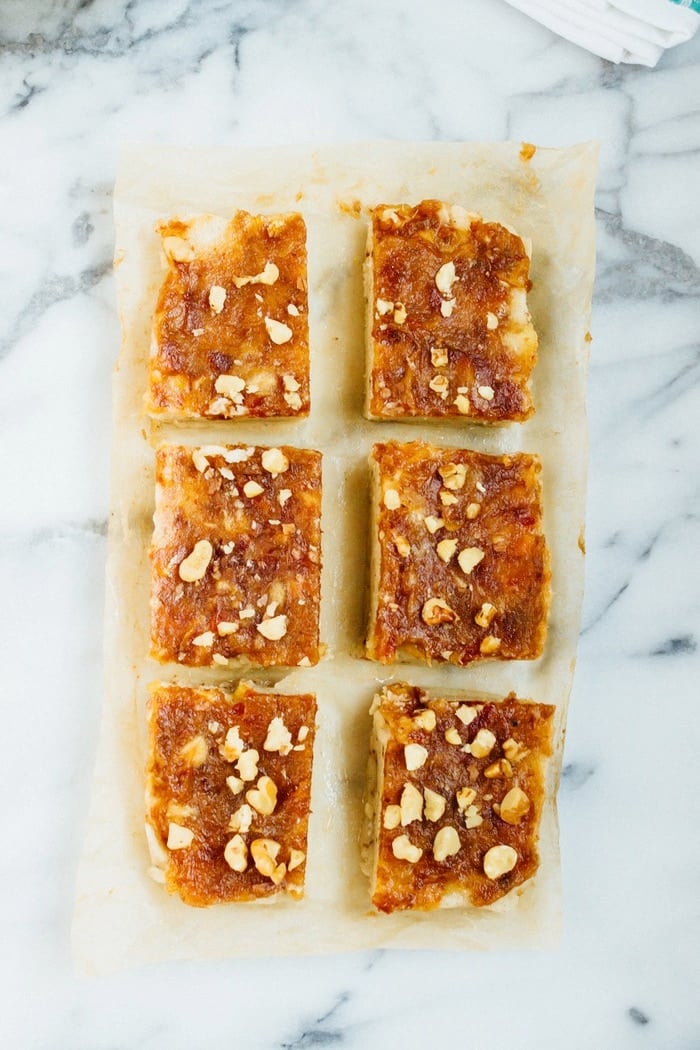 Chocolate Date Caramel Banana Ice Cream Bars sliced on parchment paper. 