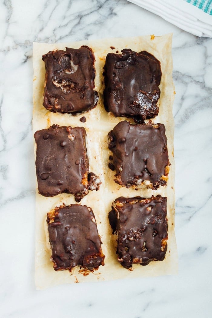 Chocolate Caramel Banana Ice Cream Bars on parchment paper. 