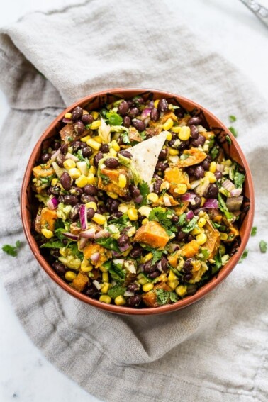 Southwest sweet potato dip in a brown bowl on a neutral colored linen napkin.