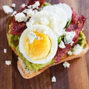 Close up shot of a slice of Cobb salad avocado toast.