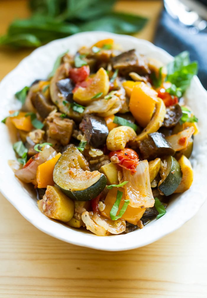 A serving platter with slow cooker ratatouille piled a top it.