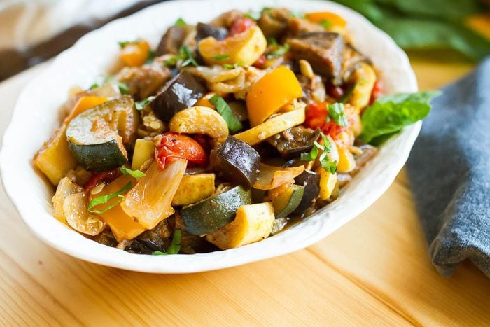 Slow Cooker Ratatouille // Load your summer farmers market haul into the slow cooker for a delicious ratatouille that you can use in a variety of ways. Serve as a side, over pasta or bread, with a grilled protein or even in an omelet. A serving dish full of ratatouille.