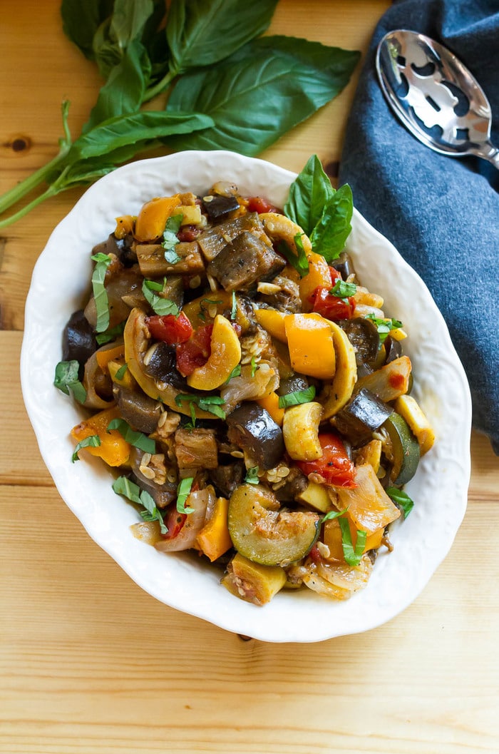 Slow Cooker Ratatouille // Load your summer farmers market haul into the slow cooker for a delicious ratatouille that you can use in a variety of ways. Serve as a side, over pasta or bread, with a grilled protein or even in an omelet. Overhead photo of a serving dish full of ratatouille.