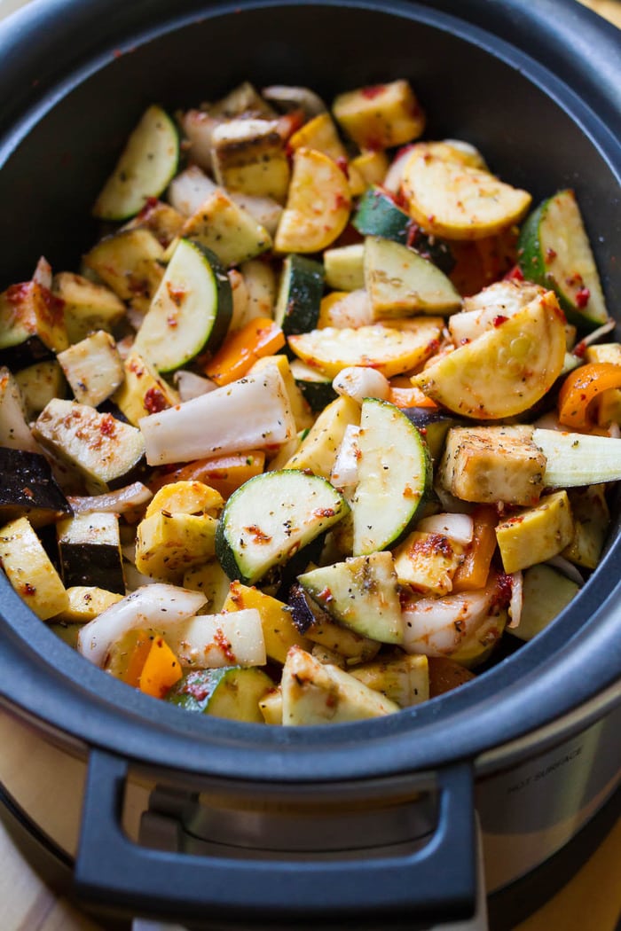 A slow cooker full of ingredients for ratatouille.