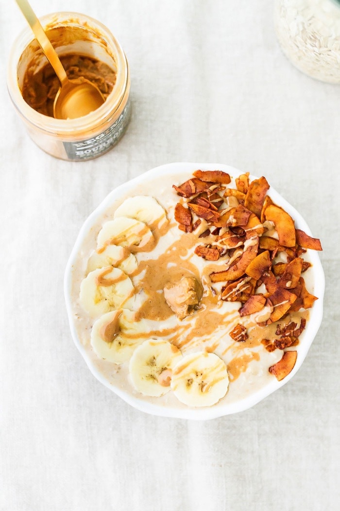 An overhead photo of a bowl of peanut butter banana and bacon overnight oats.