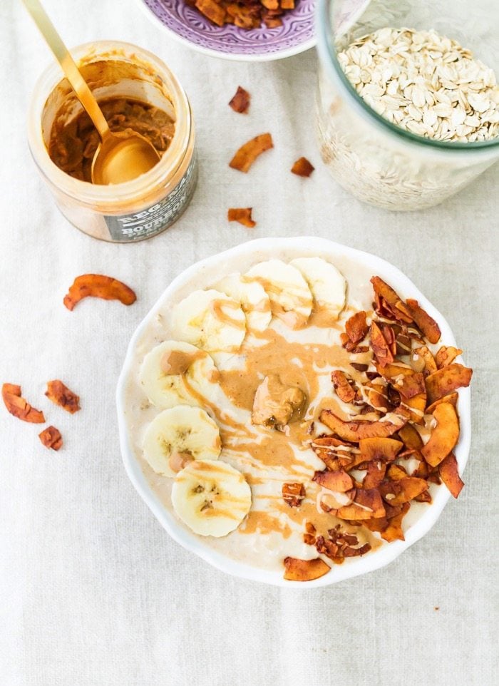 An overhead photo of a bowl of peanut butter banana and bacon overnight oats.