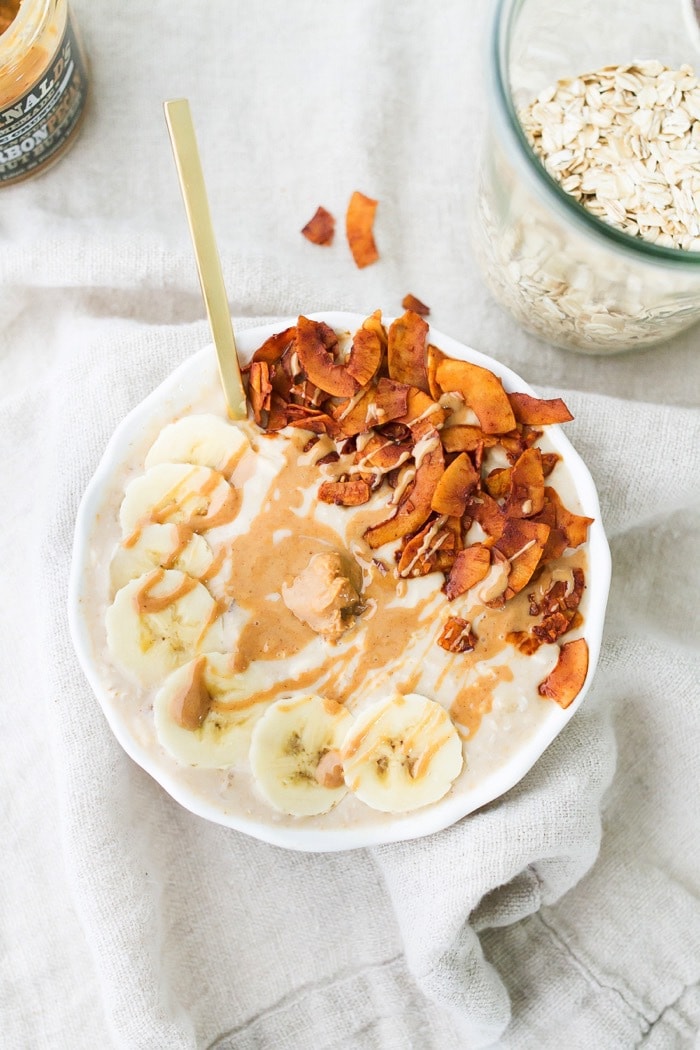 An overhead photo of a bowl of peanut butter banana and bacon overnight oats.