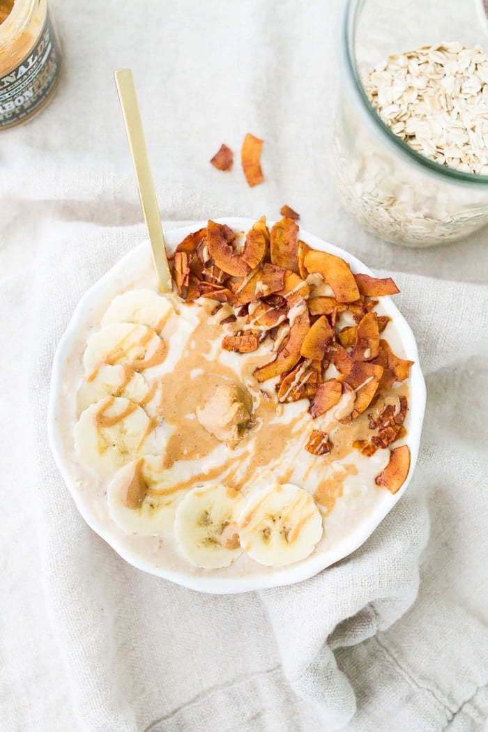 An overhead photo of a bowl of peanut butter banana and bacon overnight oats.