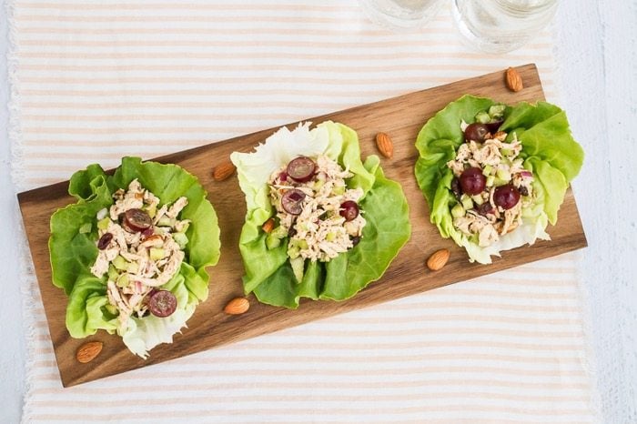 Almond butter chicken salad made with almonds, celery and grapes in lettuce cups.