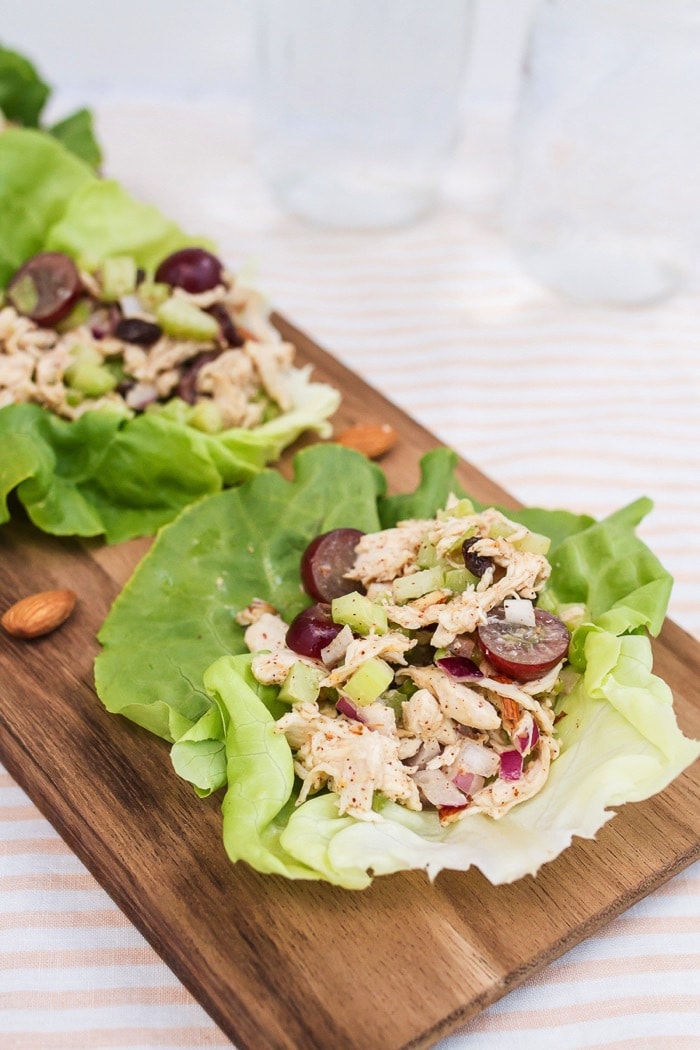 Almond butter chicken salad made with almonds, celery and grapes in lettuce cups.