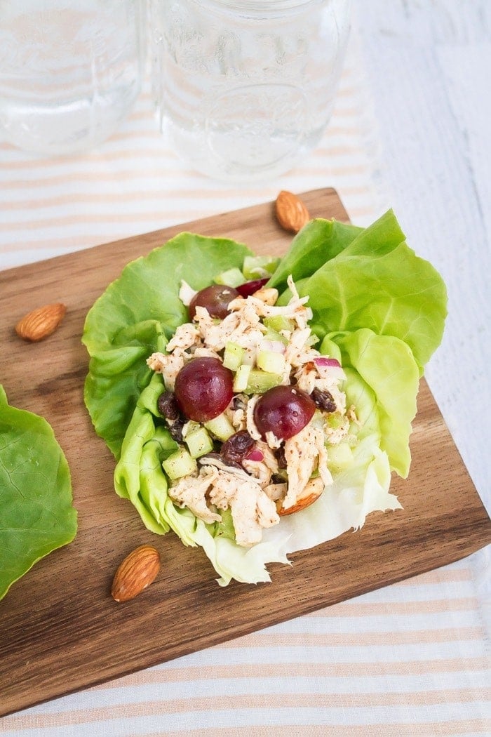 Almond butter chicken salad made with almonds, celery and grapes in lettuce cups.