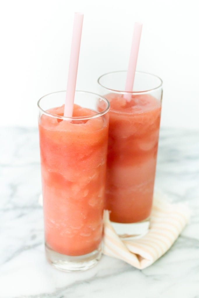 two glasses of strawberry frose with straws