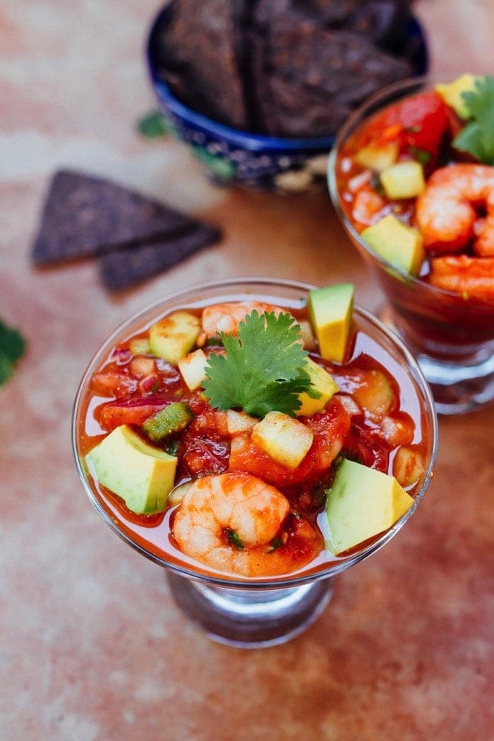 Mexican shrimp cocktail in a glass with tomatoes and avocado.