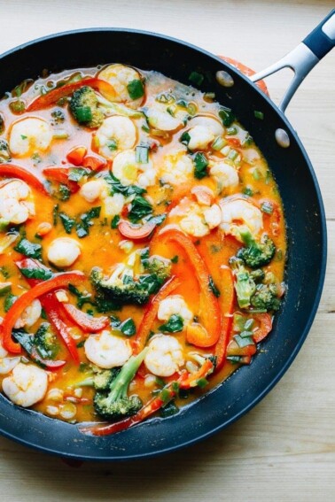 Thai coconut curry shrimp with broccoli, red pepper and shrimp in a pan.