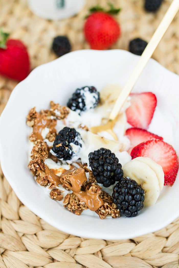 Berry Yogurt Breakfast Bowls with plain yogurt, strawberries, blackberries, banana, granola and a drizzle of peanut butter 